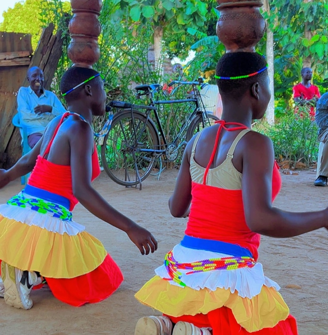 A local dance group entertaining tourists in Amor village, Pakwach recently